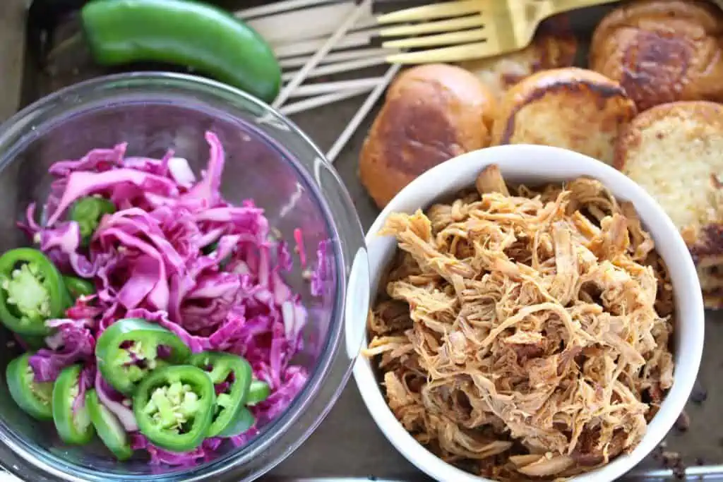 Pulled pork, cabbage and buns on sheet pan.