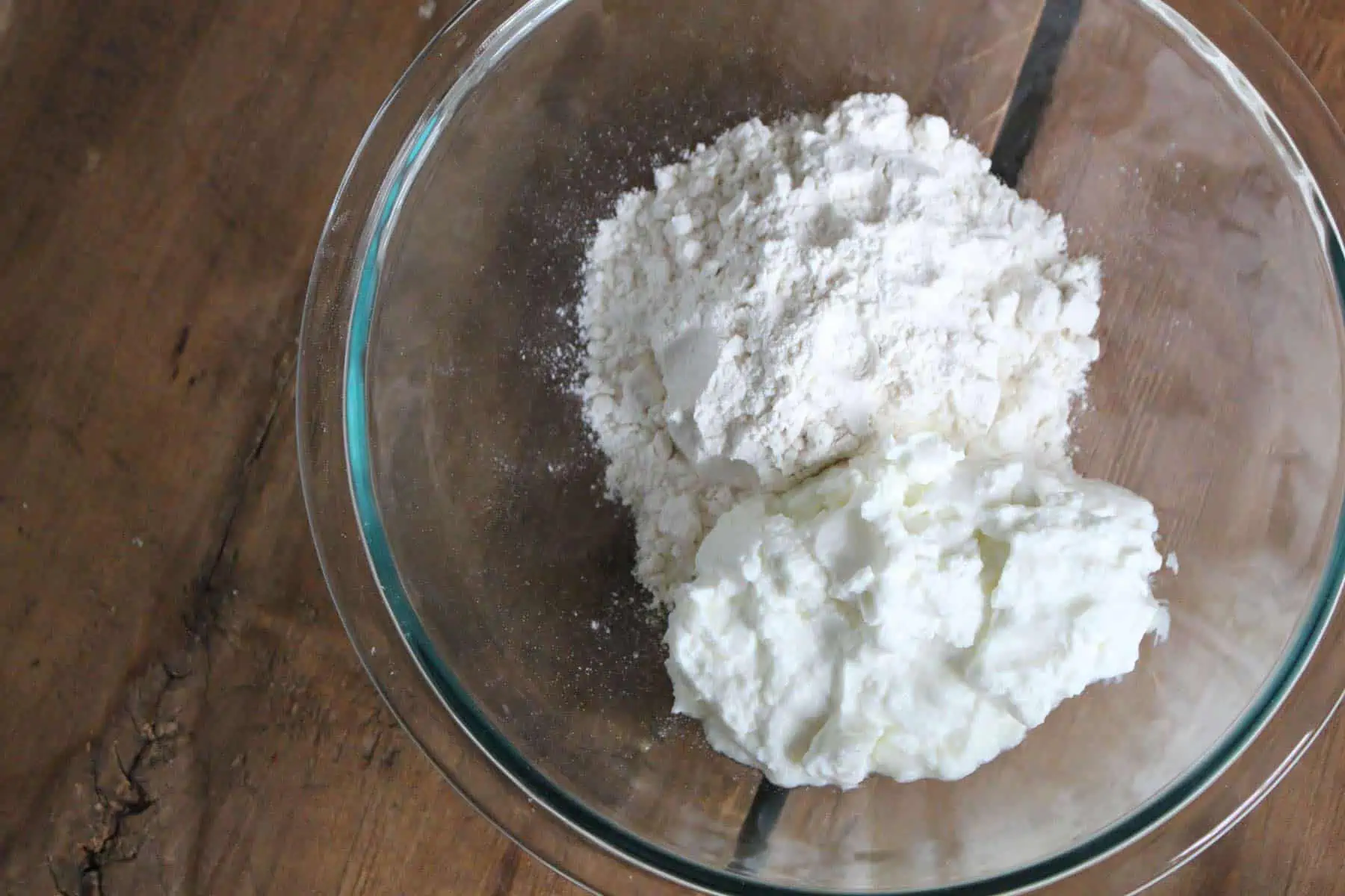 Flour and yogurt in glass mixing bowl.